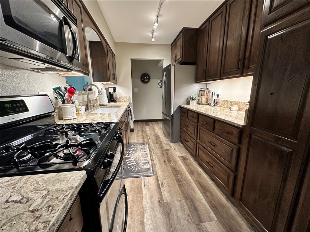 6615 Flag Mine Road Kingman, AZ 86401 - Photo 17 of 72 a kitchen with stainless steel appliances granite countertop a refrigerator and stove