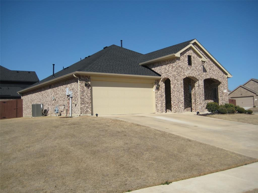 2 Grouse Run Sanger, TX 76266 - Photo 24 of 26 a front view of a house with a yard and garage