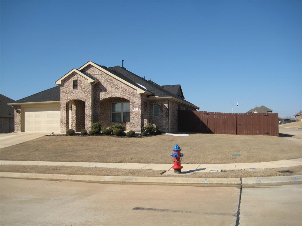 2 Grouse Run Sanger, TX 76266 - Photo 25 of 26 a front view of a house with a yard and garage