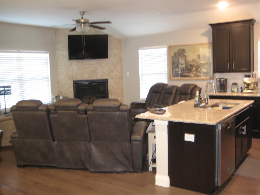 2 Grouse Run Sanger, TX 76266 - Photo 7 of 26 a living room with furniture a flat screen tv and a fireplace