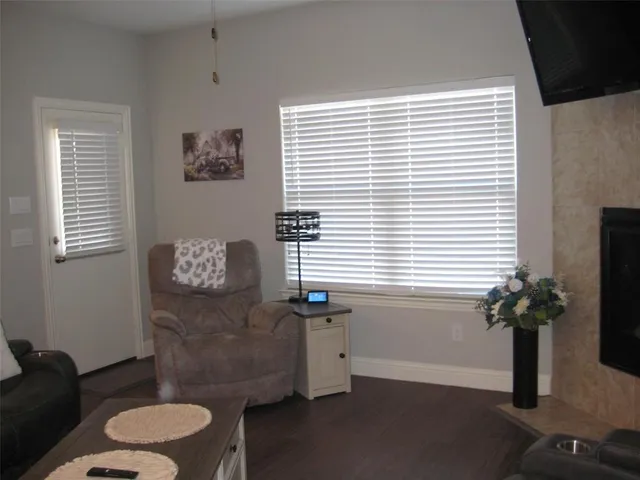 a bathroom with a toilet a potted plant and a window