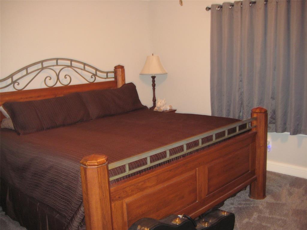 2 Grouse Run Sanger, TX 76266 - Photo 9 of 26 a bed sitting in a bedroom next to a window