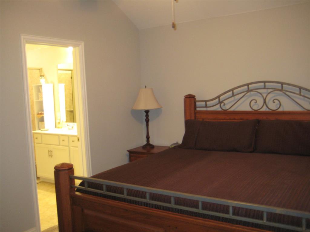 2 Grouse Run Sanger, TX 76266 - Photo 10 of 26 a bed sitting in a bedroom next to a window