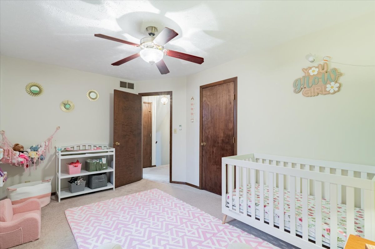 1014 North Fell Avenue Normal, IL 61761 - Photo 15 of 31 a bedroom with furniture and a chandelier fan