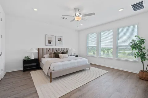 a spacious bedroom with a large bed and a large window