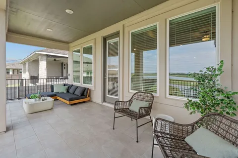 a balcony with furniture and a potted plant