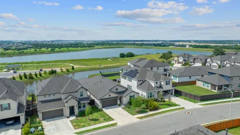 an aerial view of a house with a garden and lake view