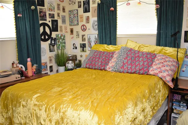 a bed sitting in a bedroom next to a window