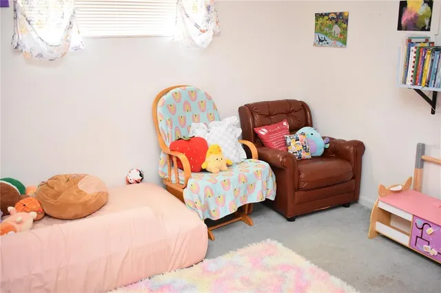a bedroom with two beds and painting on the wall
