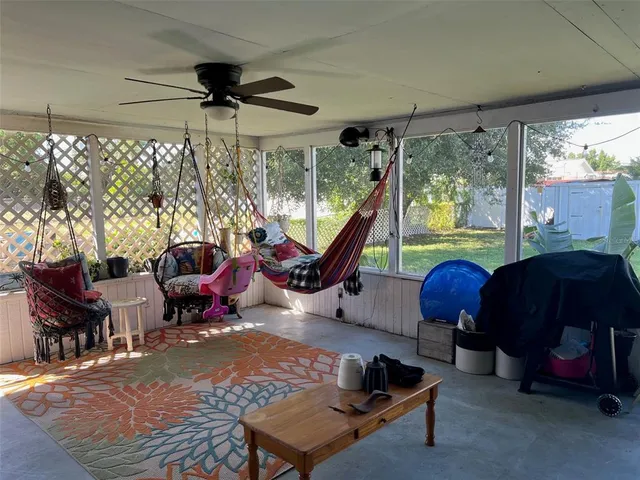 a living room with furniture a flat screen tv and a large window