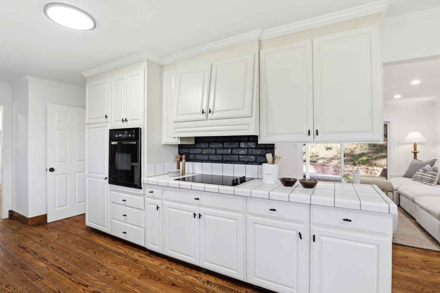 425 Summit Spring Road Woodside, CA 94062 - Photo 14 of 42 a kitchen with stainless steel appliances white cabinets and a sink
