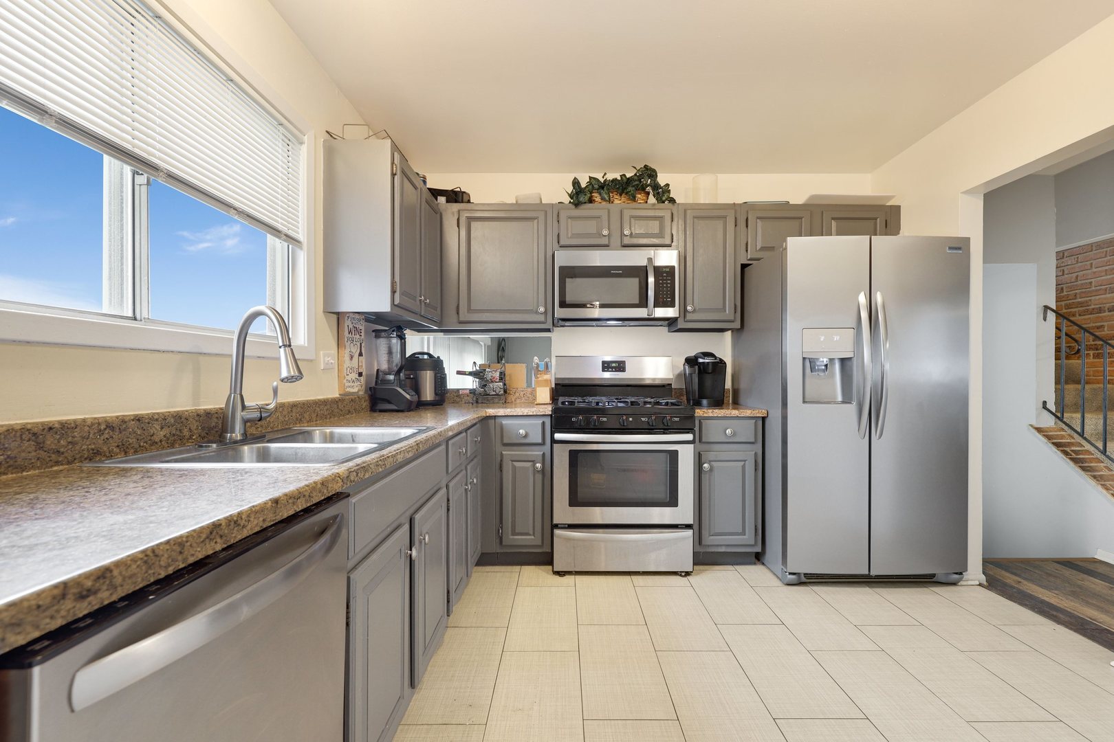 223 Pheasant Road Matteson, IL 60443 - Photo 6 of 19 a kitchen with stainless steel appliances granite countertop a sink stove and refrigerator