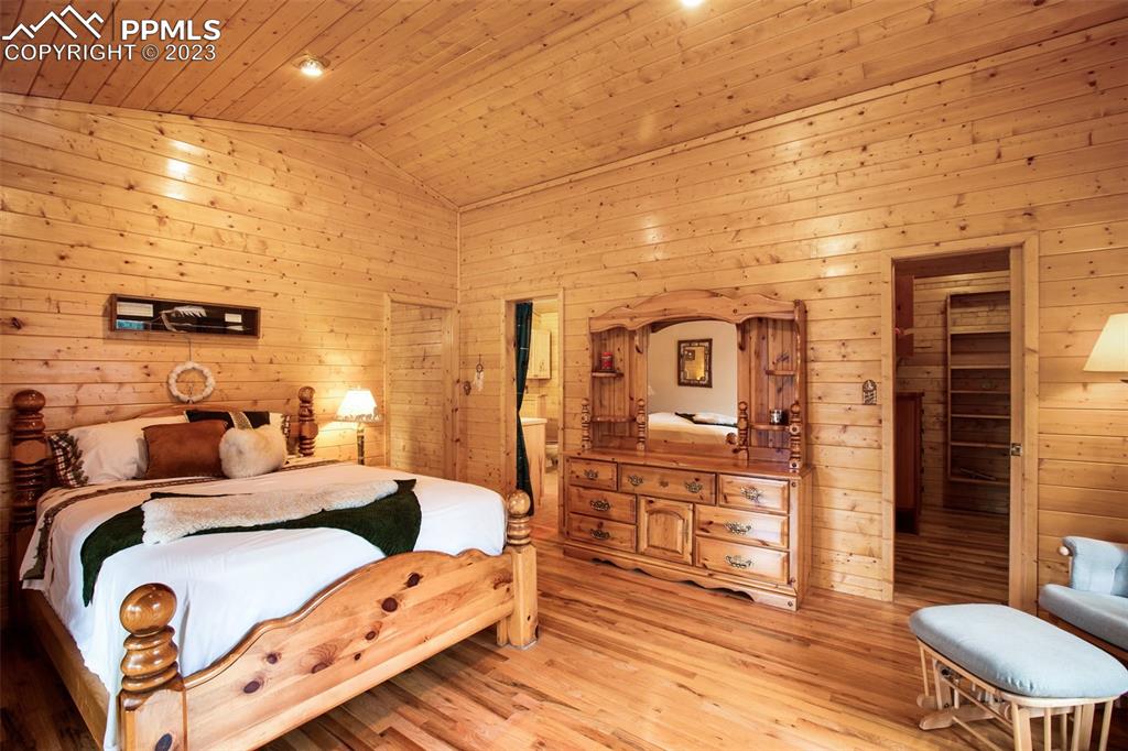 265 Broken Wheel Drive Divide, CO 80814 - Photo 11 of 50 a bedroom with a bed and wooden floor