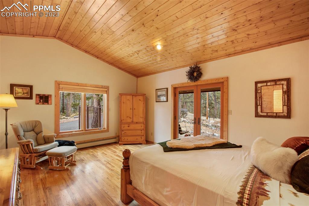 265 Broken Wheel Drive Divide, CO 80814 - Photo 13 of 50 a bedroom with a bed and wooden floor