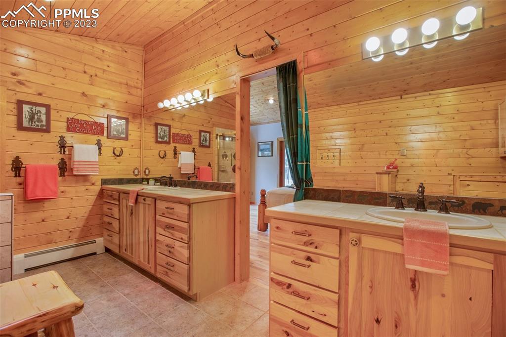 265 Broken Wheel Drive Divide, CO 80814 - Photo 14 of 50 a bathroom with a sink double vanity and a mirror