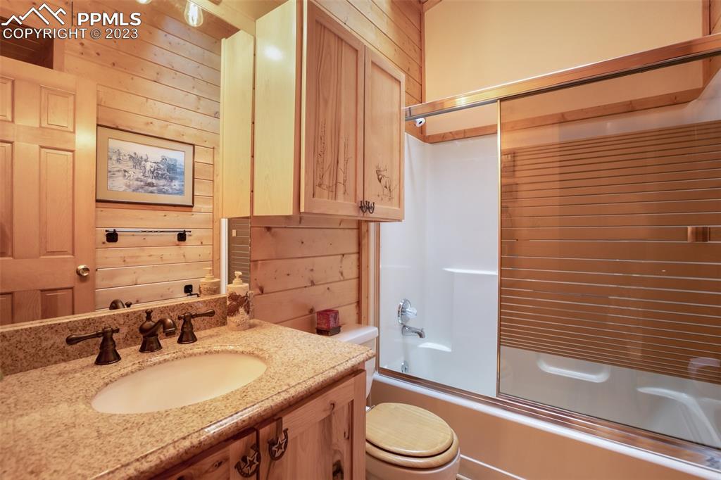 265 Broken Wheel Drive Divide, CO 80814 - Photo 20 of 50 a bathroom with a granite countertop sink toilet and shower