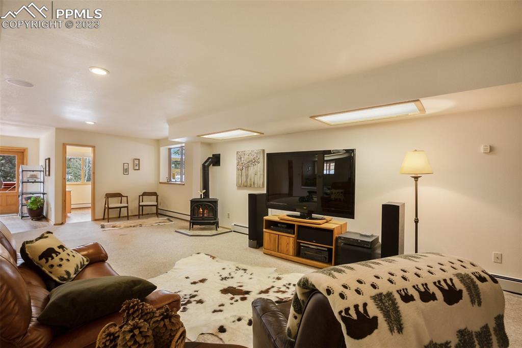 265 Broken Wheel Drive Divide, CO 80814 - Photo 22 of 50 a bedroom with a bed and flat screen tv