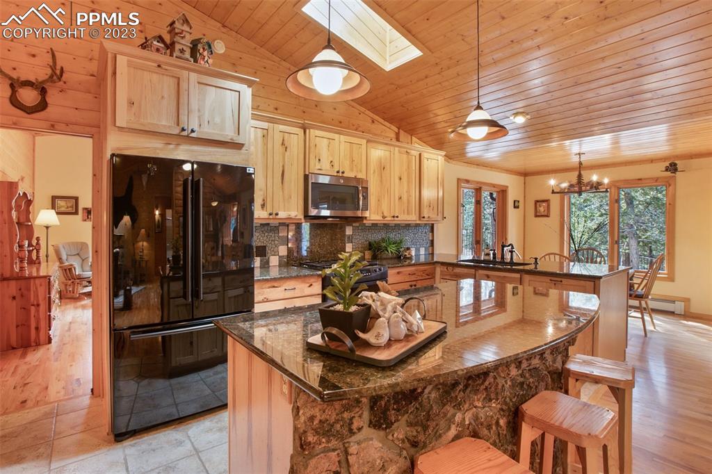 265 Broken Wheel Drive Divide, CO 80814 - Photo 4 of 50 a kitchen with stainless steel appliances granite countertop a stove refrigerator and cabinets