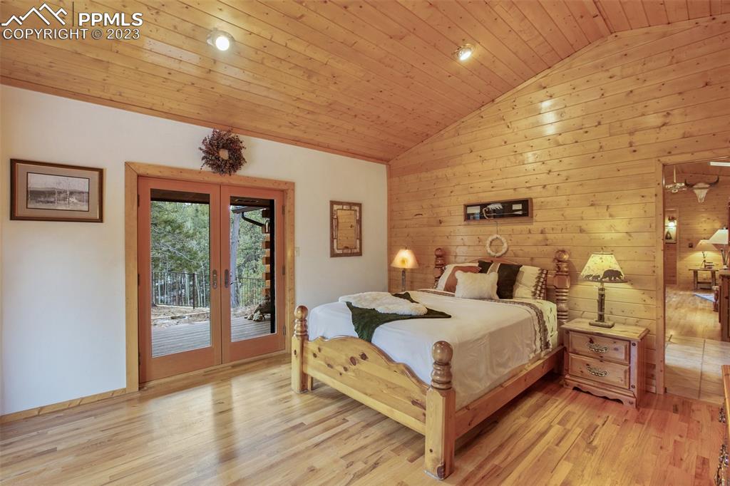 265 Broken Wheel Drive Divide, CO 80814 - Photo 10 of 50 a large bedroom with a bed and wooden floor