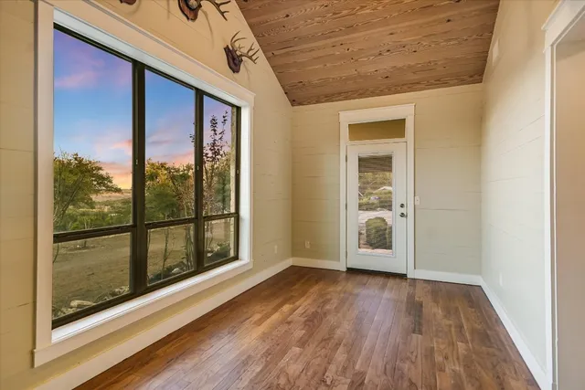 a view of an empty room with a empty space and wooden shelves