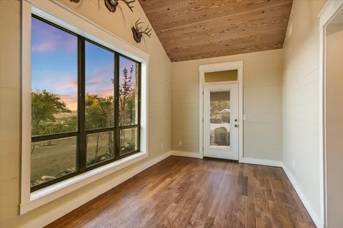 a view of an empty room with a empty space and wooden shelves