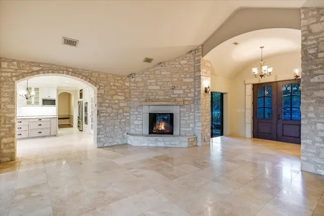 a view of an empty room with a fireplace and a window