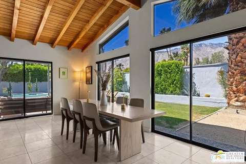 a view of a dining room with furniture window and outside view