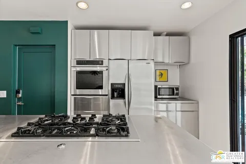 a kitchen with wooden cabinets and a stove top oven