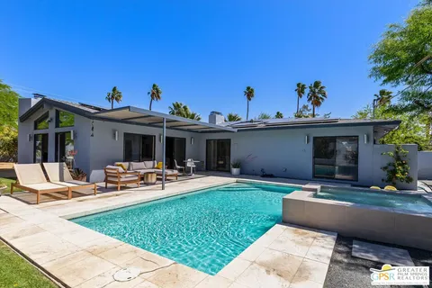 a view of a house with backyard sitting area and porch