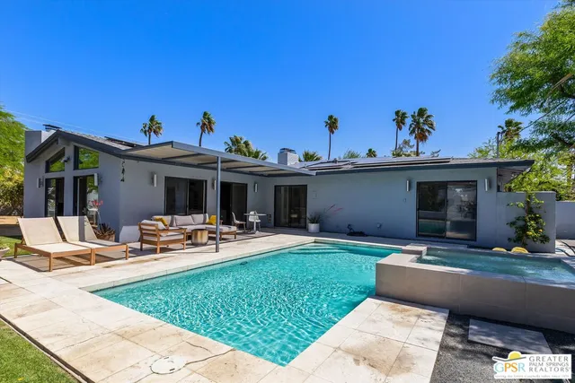 a view of a house with backyard sitting area and porch
