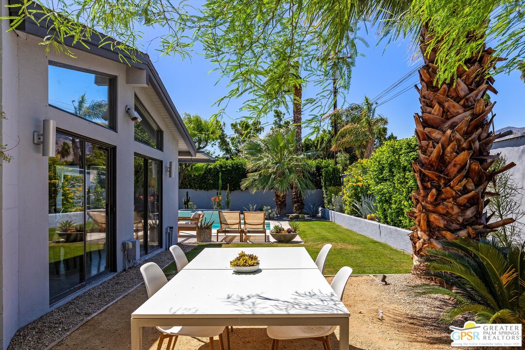 1465 North Rodeo Road Palm Springs, CA 92262 - Photo 31 of 43 a view of a patio with couches table and chairs and potted plants
