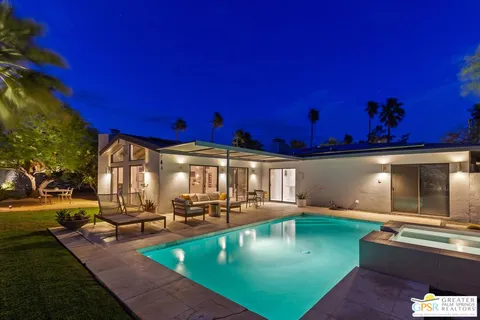 a view of a swimming pool with outdoor seating
