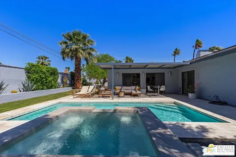 a view of a house with backyard porch and sitting area
