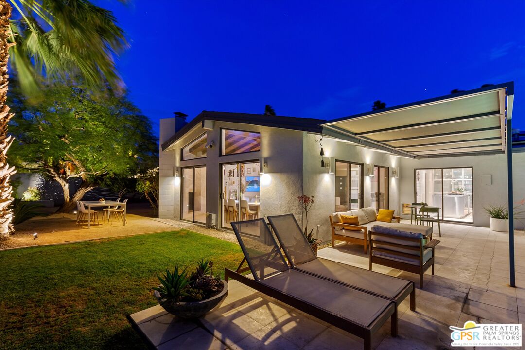 1465 North Rodeo Road Palm Springs, CA 92262 - Photo 37 of 43 a view of a hall with couches chairs and a yard