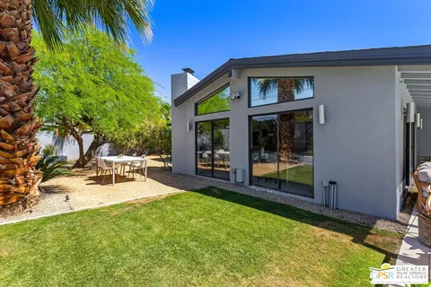 a view of a house with backyard porch and sitting area