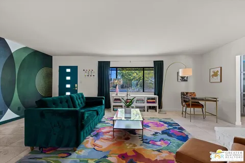 a living room with furniture and a dining table