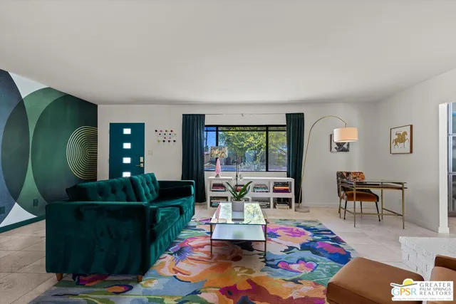 a living room with furniture and a dining table