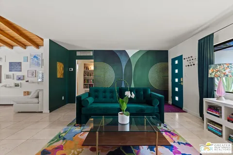 a living room with furniture a rug and entryway