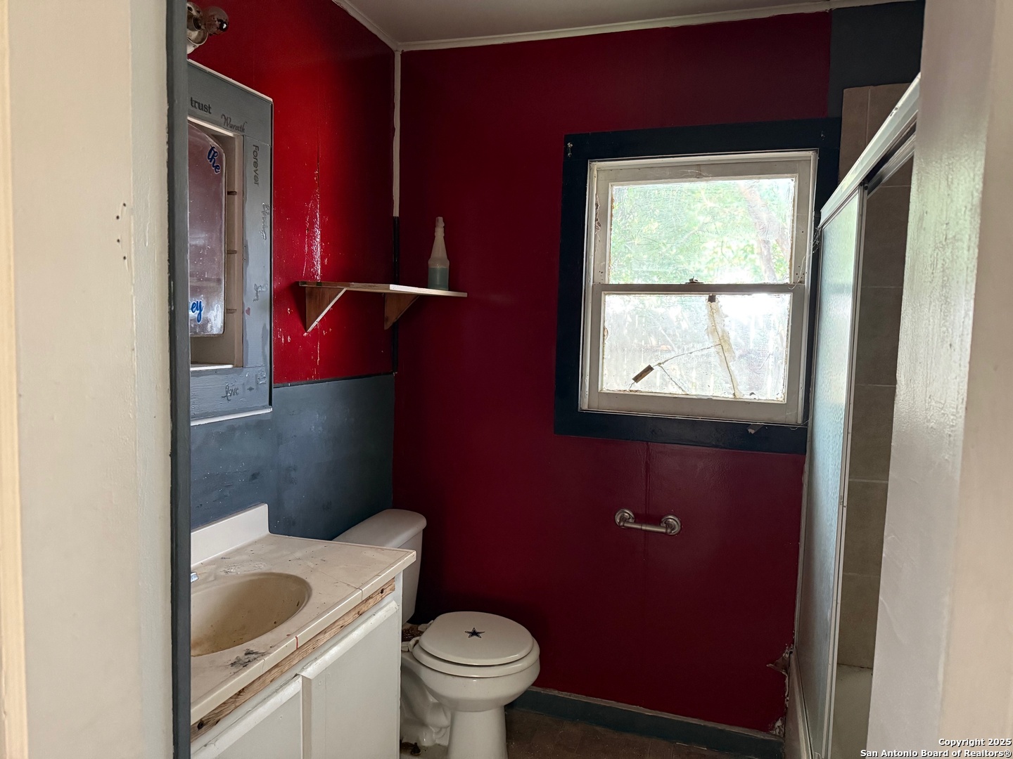 1210 King David Drive Three Rivers, TX 78071 - Photo 12 of 17 a bathroom with a granite countertop toilet a sink and a window