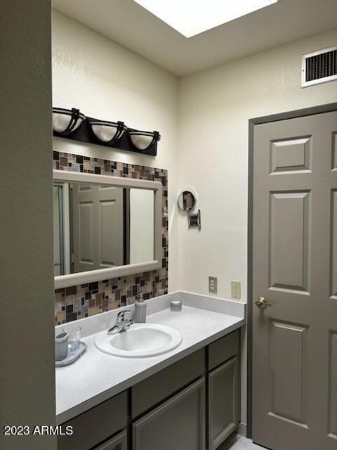 1172 West Mountain View Green Valley, AZ 85622 - Photo 12 of 35 a bathroom with a sink and a mirror