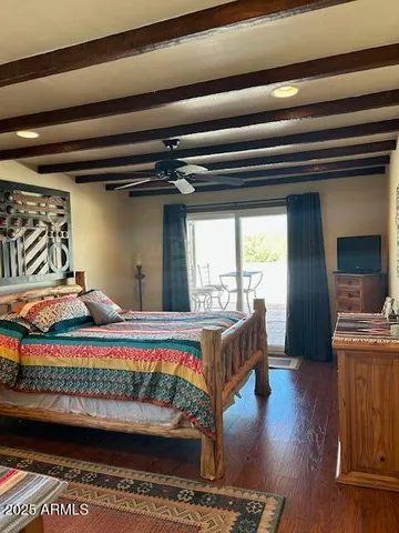 a bedroom with furniture and a wooden floor