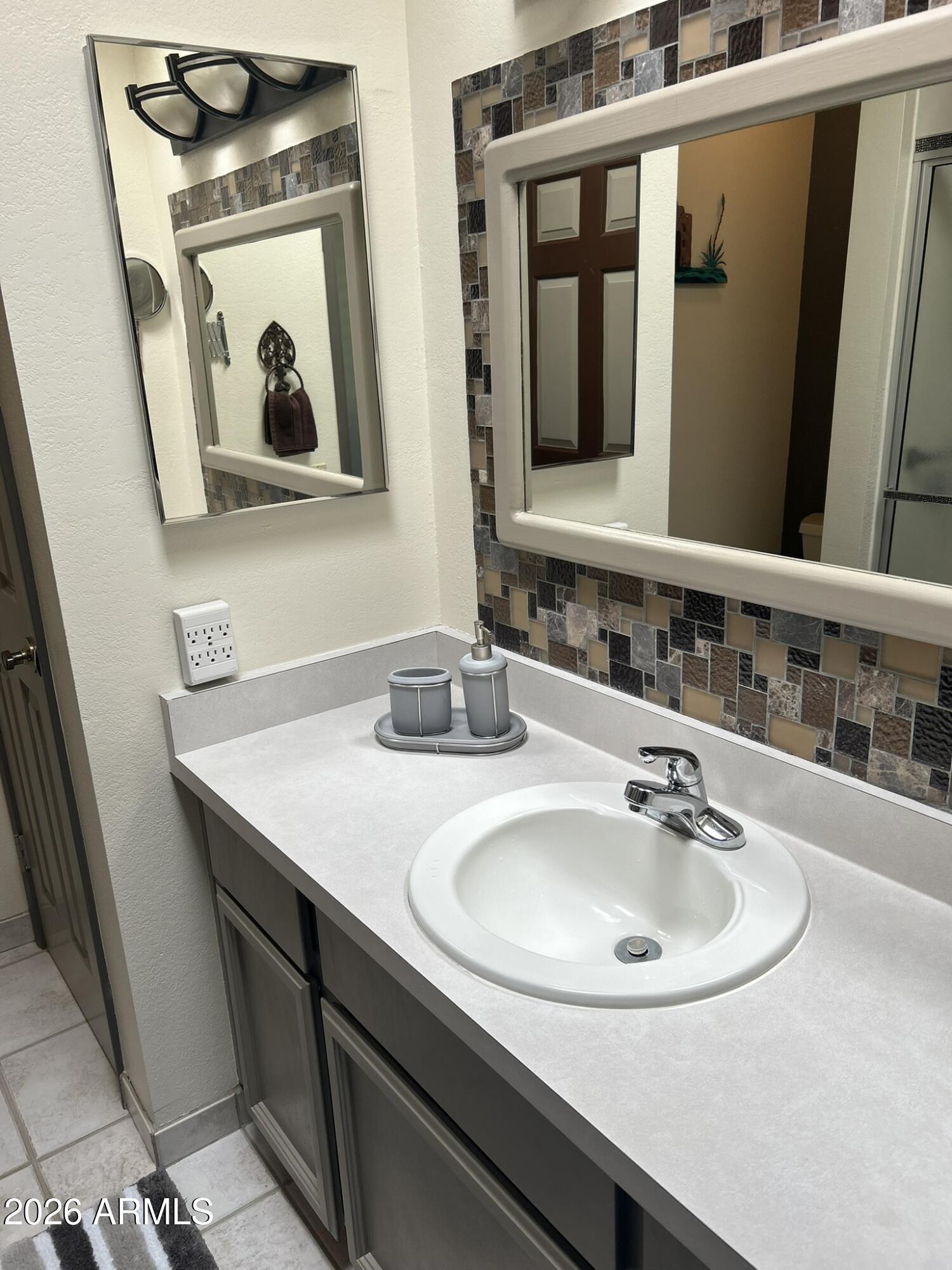 1172 West Mountain View Green Valley, AZ 85622 - Photo 15 of 35 a bathroom with double vanity sink and mirror