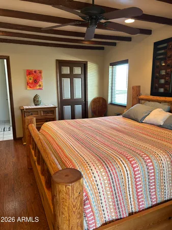 a bed sitting in a bedroom next to a window