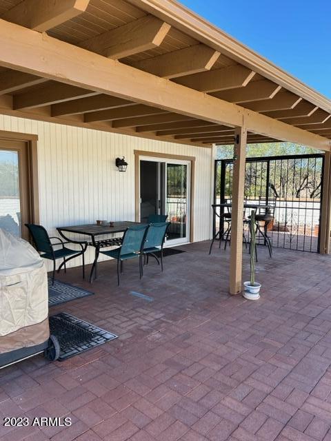 1172 West Mountain View Green Valley, AZ 85622 - Photo 22 of 25 a view of a patio with table and chairs a barbeque