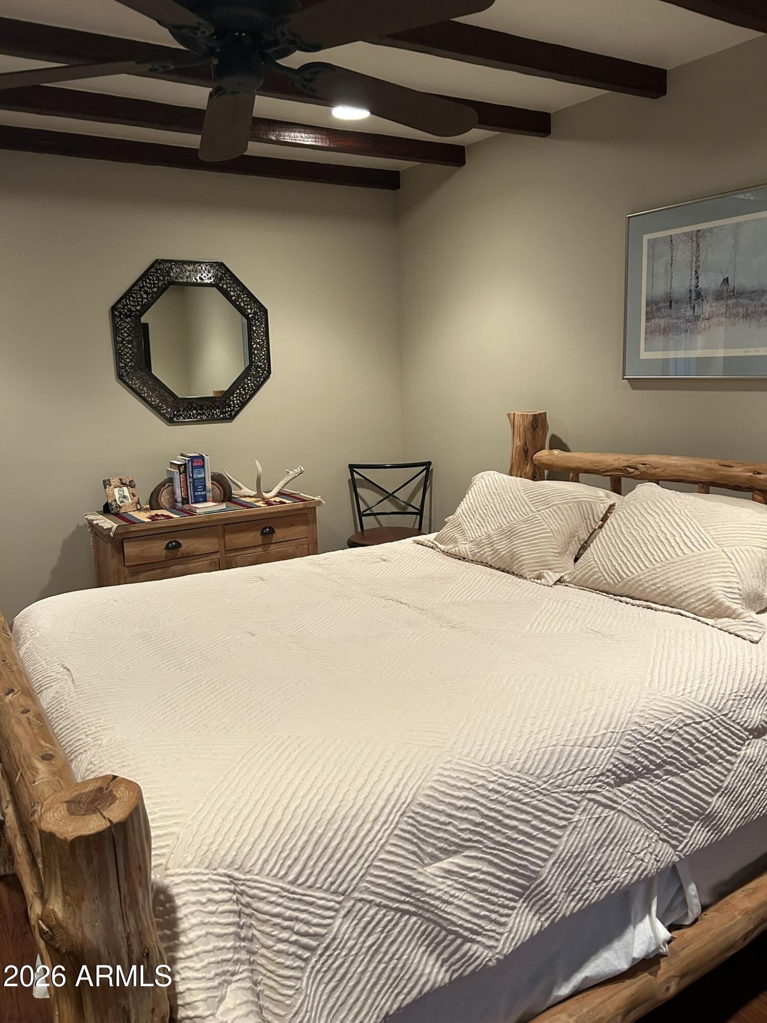 1172 West Mountain View Green Valley, AZ 85622 - Photo 23 of 35 a bedroom with a bed and a chandelier