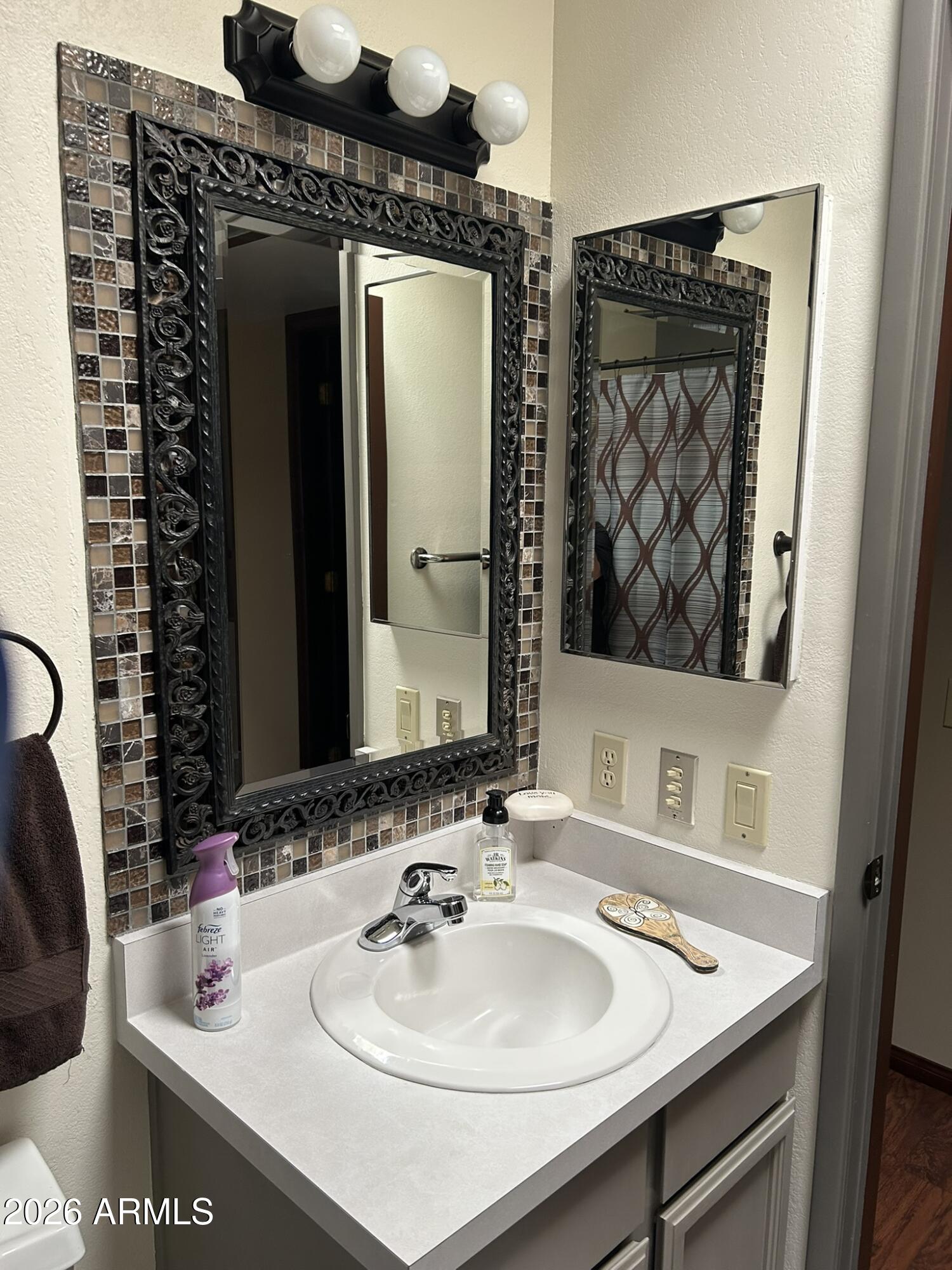 1172 West Mountain View Green Valley, AZ 85622 - Photo 25 of 35 a bathroom with a sink and a mirror