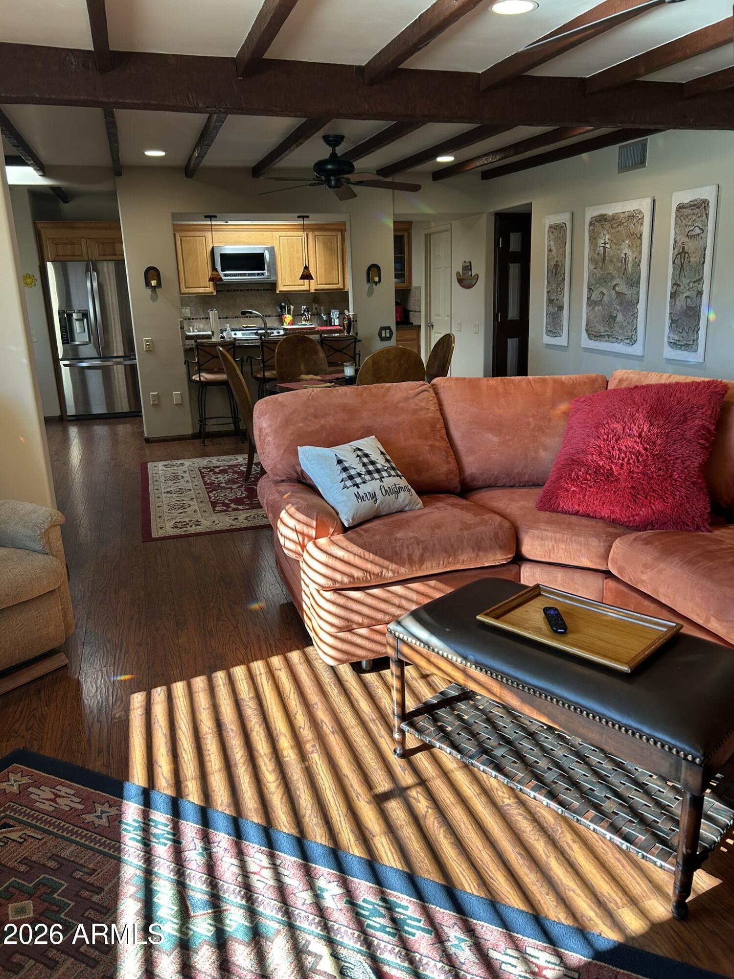 1172 West Mountain View Green Valley, AZ 85622 - Photo 31 of 35 a living room with furniture a flat screen tv and a table