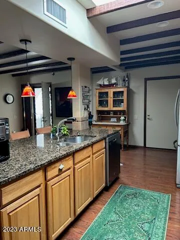 a kitchen with stainless steel appliances granite countertop a sink and a stove
