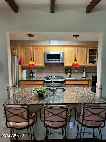 a kitchen with a stove a sink and a microwave