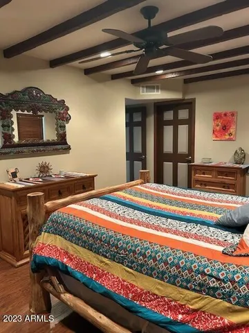 a bedroom with bed and a book shelf